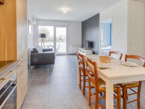 a kitchen and living room with a table and chairs at Apartment Le Clos Fontaine by Interhome in Saint Malo