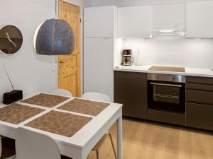 A kitchen or kitchenette at Holiday Home Rukaköngäs 20 includes one ski lift tick by Interhome