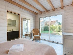 a bedroom with a bed and a large window at Holiday Home Villa Horizon by Interhome in Lacanau-Océan
