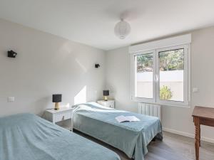 a bedroom with two beds and a window at Holiday Home Villa Horizon by Interhome in Lacanau-Océan