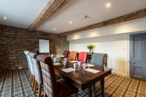 a dining room with a wooden table and chairs at The Greyhound Hotel in Shap