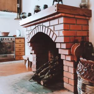 a brick fireplace in the middle of a kitchen at O Palheiro in Bragança