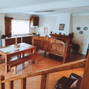 a living room with wooden furniture and a table at O Palheiro in Bragança