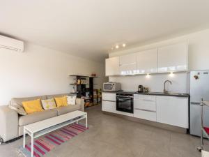 een woonkamer met een bank en een keuken bij Studio De la Plage-3 by Interhome in Cavalaire-sur-Mer