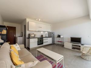 een woonkamer met een bank en een keuken bij Studio De la Plage-3 by Interhome in Cavalaire-sur-Mer