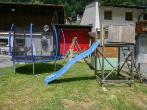 a playground with a slide and a swing set at Apartment Sesselebenerhof-1 by Interhome in See