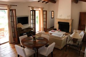 a living room with a table and chairs and a television at Villa Golf Azur in Saint-Raphaël