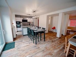 a dining room and kitchen with a table and chairs at La porte du paradis in La Roche Madoux
