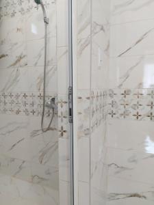 a bathroom with a shower with a glass door at Guest House Perla in Obzor +31 photos