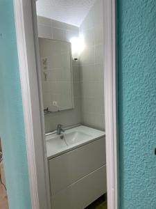 a bathroom with a sink and a mirror at Duplex Las Americas in Playa de las Americas