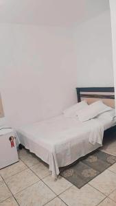 Cama ou camas em um quarto em Pousada Aquarela