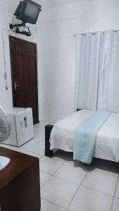 Cama ou camas em um quarto em Pousada Aquarela