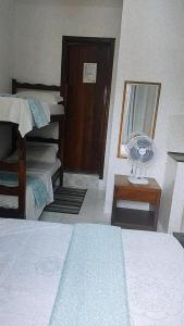 Cama ou camas em um quarto em Pousada Aquarela