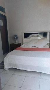 Cama ou camas em um quarto em Pousada Aquarela