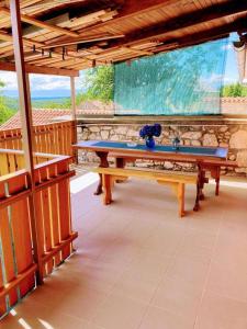 a pool table on a porch with a stone wall at Apartman Sara in Grižane
