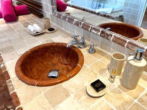 a wooden tub in a bathroom with a sink at Villa Privilege in Anse Marcel 