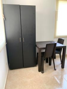 a room with a table and a black cabinet at Casa Santiago Mayor in Cali