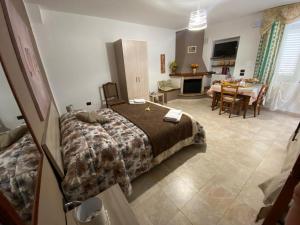 a bedroom with a bed and a dining room at B&B la Sirenetta in Diamante