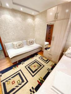 a small room with a bed and a rug at Apartments Ahmetova 6 32 in Almaty