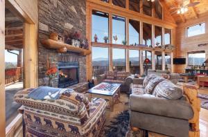 a living room with couches and a fireplace at Heavenly Vista at Crown Point cabin in Sevierville