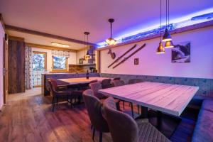 a restaurant with tables and chairs in a room at Falkensteinalm Hochkrimml in Krimml