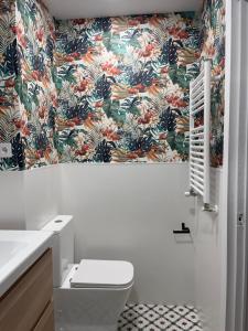 a bathroom with a toilet and a floral wallpaper at Apartment for 4 in Lejona Casa Natalia NO ELEVATOR in Leioa +36 photos