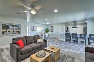 a living room with a couch and a kitchen at Merritt Island Home - Family and Pet Friendly! in Merritt Island