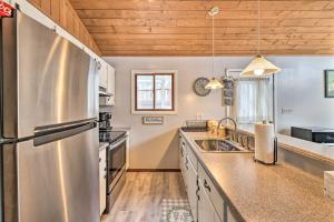 a large kitchen with a stainless steel refrigerator at Lake Ariel Home Less Than 1 Mi to Roaming Woods Lake! in Lake Ariel