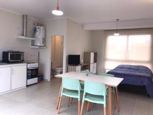 a kitchen with a table and chairs and a bed at Sol de Octubre 3 Hipólito Vieytes Norte y Talcahuano in San Juan