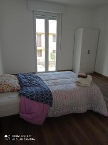 a bedroom with a bed and a large window at Franca in Lonate Ceppino