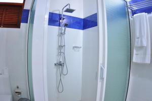 a shower in a bathroom with blue and white at Oasey Beach Hotel in Bentota +45 photos