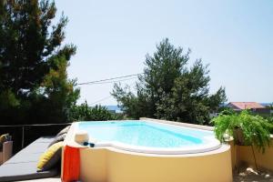 a swimming pool on the back of a house at Apartmant with Pool 8 in Kaštela