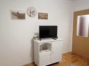 a living room with a tv on a white cabinet at Apartman Biser in Trebinje