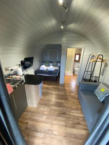 a kitchen and living room in a tiny house at Highland Stays - Ben View Studio Pod & Jacuzzi Bath in Fort William