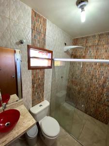 a bathroom with a toilet and a sink and a shower at Recanto Bela Vista Costa Dourada-BA in Costa Dourada