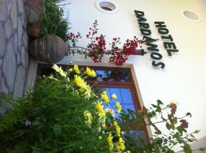 a sign on the side of a building with flowers at Dardanos Hotel in Patara