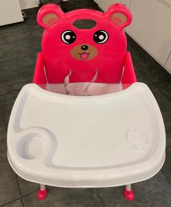 a red teddy bear sitting in a high chair at Sonnige Wohnung im Zentrum mit Terrasse u Tiefgarage - Netflix & Prime in Leipzig