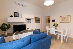 a living room with a blue couch and a table at BICOCCA HOME - 2 Bedrooms in Milan