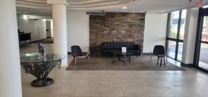 a lobby with a table and chairs and a brick wall at Tropical Palms Hotel in Clearwater