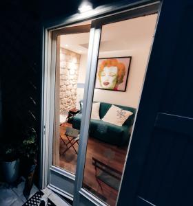 a mirror reflection of a couch in a living room at Romantic tiny house in Montmartre in Paris