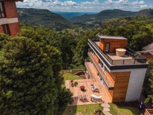 an aerial view of a house in the mountains at Suites Refugio Do Vale in Gramado