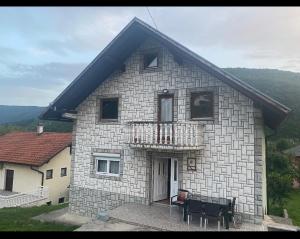 a stone house with a piano in front of it at Amar Apartmani, Jajce in Jajce