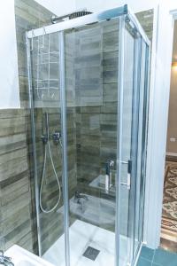 a shower with a glass door in a bathroom at TRESCA CHARME luxury Rooms in Bari