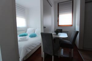 a bedroom with a bed and a table and chairs at Pegaz009**** in Vrnjačka Banja