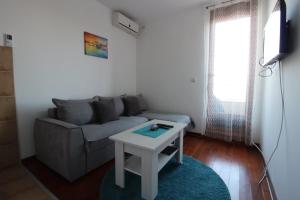a living room with a couch and a table at Pegaz009**** in Vrnjačka Banja