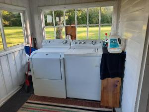 a kitchen with a stove and a washer at Charming Cottage on a City Farm! in Lexington
