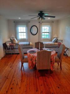 a living room with a table and a couch at Charming Cottage on a City Farm! in Lexington