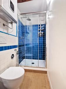a bathroom with a toilet and a shower at Alguerhome Casa Turchese old town in Alghero