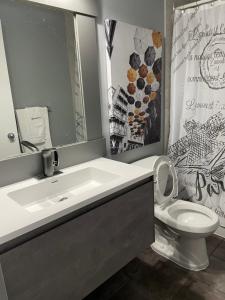 a bathroom with a sink and a toilet at Motel Valois JM inc in Acton Vale