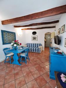 a living room with a blue table and chairs at Alguerhome Casa Turchese old town in Alghero